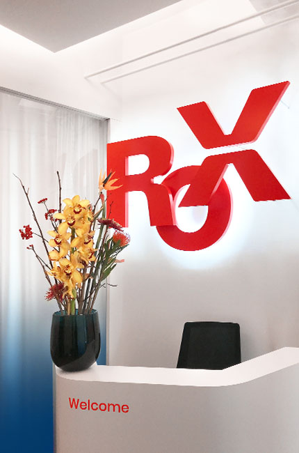 The lettering Rox in red 2D letters with a white backlight mounted on a wall