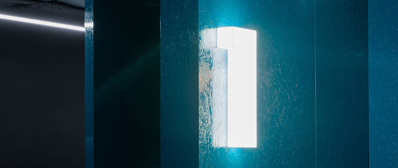 The number 1 as a 3D number shining on a blue wall